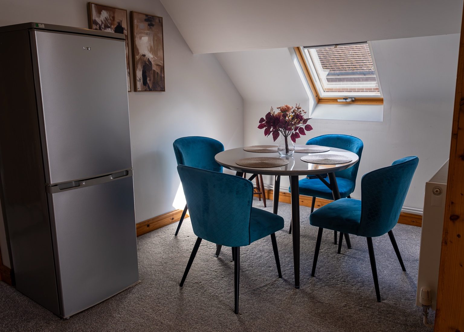 Dining nook with four blue velvet chairs